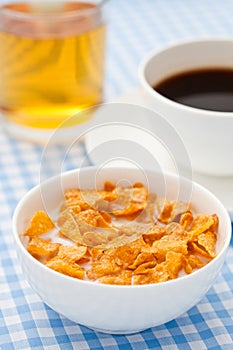 Breakfast cereal with milk, coffee and apple juice
