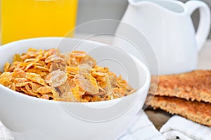 Breakfast cereal with toast and juice.