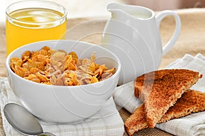 Breakfast cereal with toast and juice.