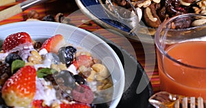 Breakfast of cereals with berries, dry fruits, milk