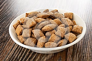 Breakfast cereals with filling in bowl on wooden table