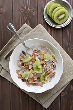 Breakfast cereals with milk and kiwi