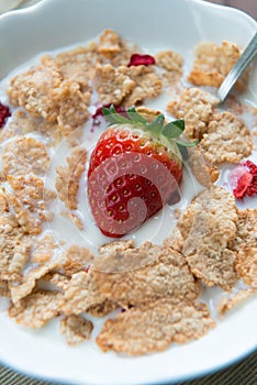 Breakfast cereals with milk and strawberries