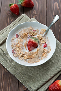 Breakfast cereals with milk and strawberries