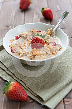 Breakfast cereals with milk and strawberries