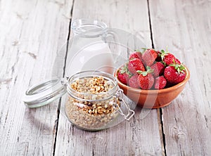 Breakfast with cereals, milk and strawberries