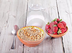 Breakfast with cereals, milk and strawberries