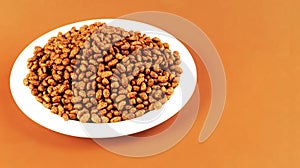 Breakfast with chocolate rice on light brown background, side view. Space for text