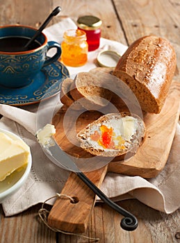 Breakfast with coffee, bread, butter and jam