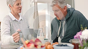 Breakfast, coffee and couple with a senior man and woman eating a meal and drinking at a table together in their house