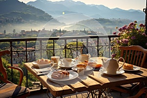 Breakfast with coffee and fresh pastries on the terrace overlooking the mountains