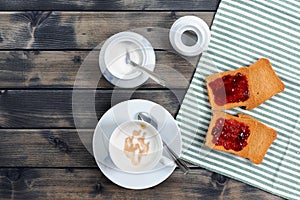 Breakfast with coffee milk and rusks with jam