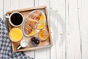 Breakfast with coffee, orange juice jam and fresh croissant