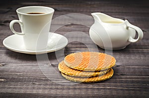 Breakfast: coffee with waffles and milk/breakfast: coffee with waffles and milk on a dark wooden background. Selective focus