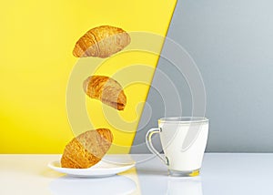 breakfast concept cup of milk and flying croissants