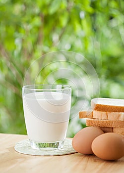 Breakfast concept with fresh eggs,milk glass and bread
