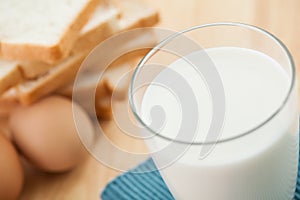Breakfast concept with fresh eggs,milk glass and bread