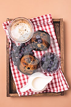 Breakfast Concept Homemade Muffins with Blueberry Coffee and Milk Served on Wooden Tray Vertical