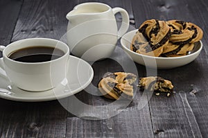 breakfast with cookies, cup of coffee and cream/breakfast with cookies, cup of coffee and cream on a dark wooden background