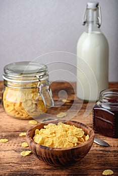 Breakfast with corn flakes, milk and jam