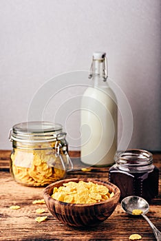 Breakfast with corn flakes, milk and jam