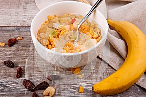Breakfast, corn flakes with a spoon, raisins, bananas on burlap.