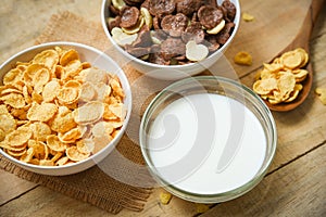 Breakfast Cornflakes and various cereals bowl and milk cup on wooden background for cereal healthy food