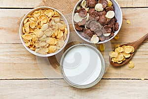 Breakfast Cornflakes and various cereals in bowl and milk cup on wooden background for cereal healthy food