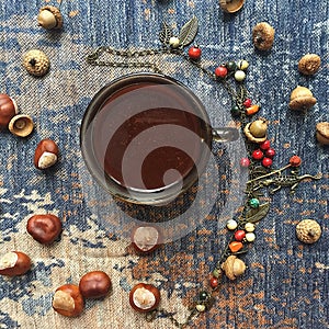 Coffee flatlay with chestnuts, acorn and fantasy berries forrest necklage