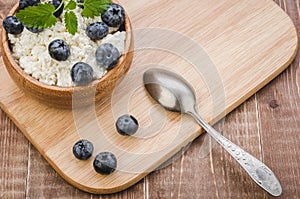 breakfast with cottage cheese and blueberry on a wooden tray/breakfast with cottage cheese and blueberry on a wooden tray. Top