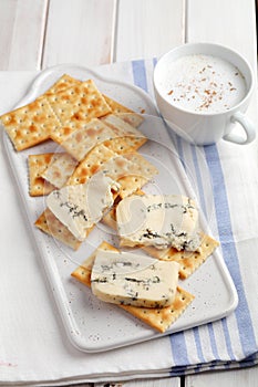 Breakfast with crackers, blue cheese, and coffee