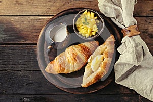 Breakfast with croissant and mango fruit