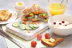 Breakfast with croissant sandwich, rice, Casas berries, boiled e