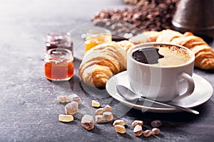 Breakfast with cup of coffee, croissant and fruit jam