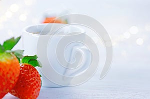 Breakfast. Cup of coffee and strawberries over white background