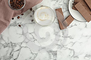 Breakfast with delicious wafers and coffee on white marble table, flat lay. Space for text