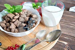 Breakfast dried chocolate pads on dark wooden background. Healthy tasty breakfast chocolate square pads with