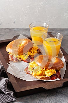 Breakfast egg and bacon sandwich on bagel with cheese