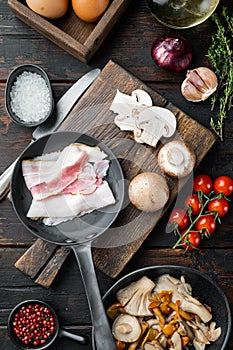Breakfast egg ingredients, on old dark  wooden table background, top view flat lay