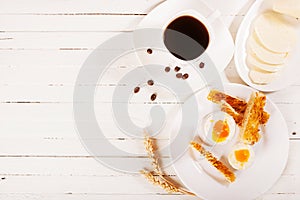 Breakfast with eggs and coffee on a white background