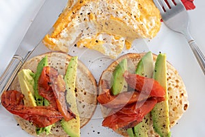 Breakfast of eggs muffin avacado and tomatoes