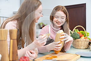 Breakfast with the family. In the morning, a mother and her daughter cut bread and cheese