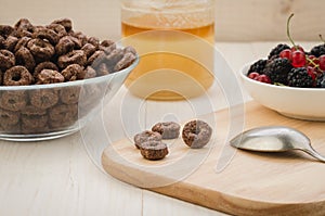 breakfast with flakes, berries, honey/breakfast with flakes, berries, honey on a wooden tray. selective focus