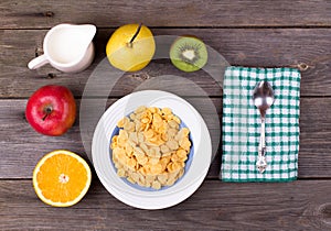 Breakfast: flakes in a plate, milk in a jug