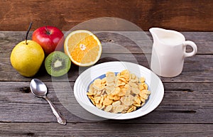 Breakfast: flakes in a plate, milk in a jug