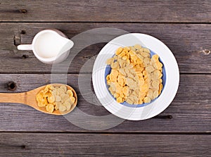 Breakfast: flakes in a plate, milk in a jug