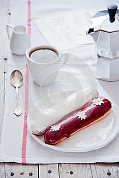 Breakfast with French colorful eclairs with coffee cup