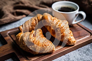Breakfast with fresh croissants and cup of black coffee
