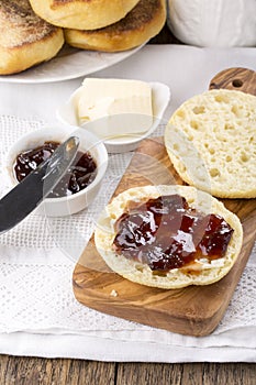 Breakfast. Fresh homemade English muffins with butter and jam