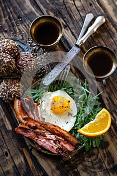 Breakfast with fried egg and becon in rustic stile